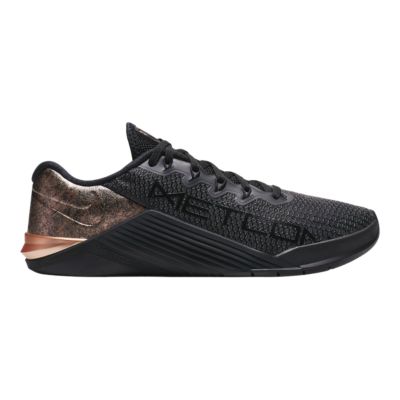 rose gold and black tennis shoes